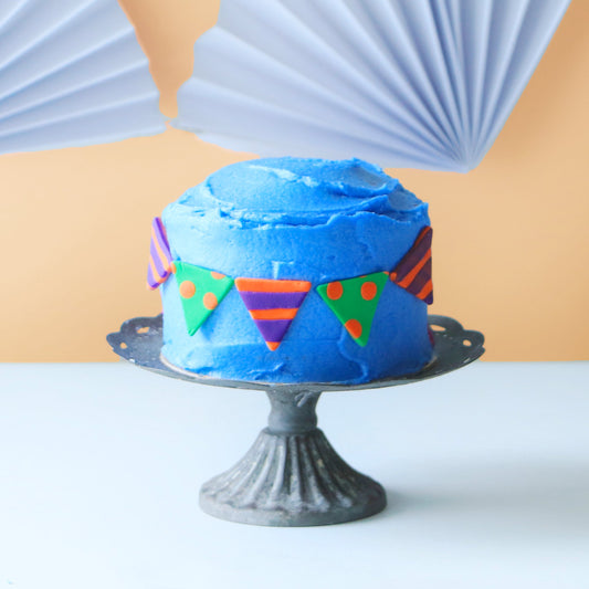 Fondant patterned with polka dots and stripes on a mini cake.