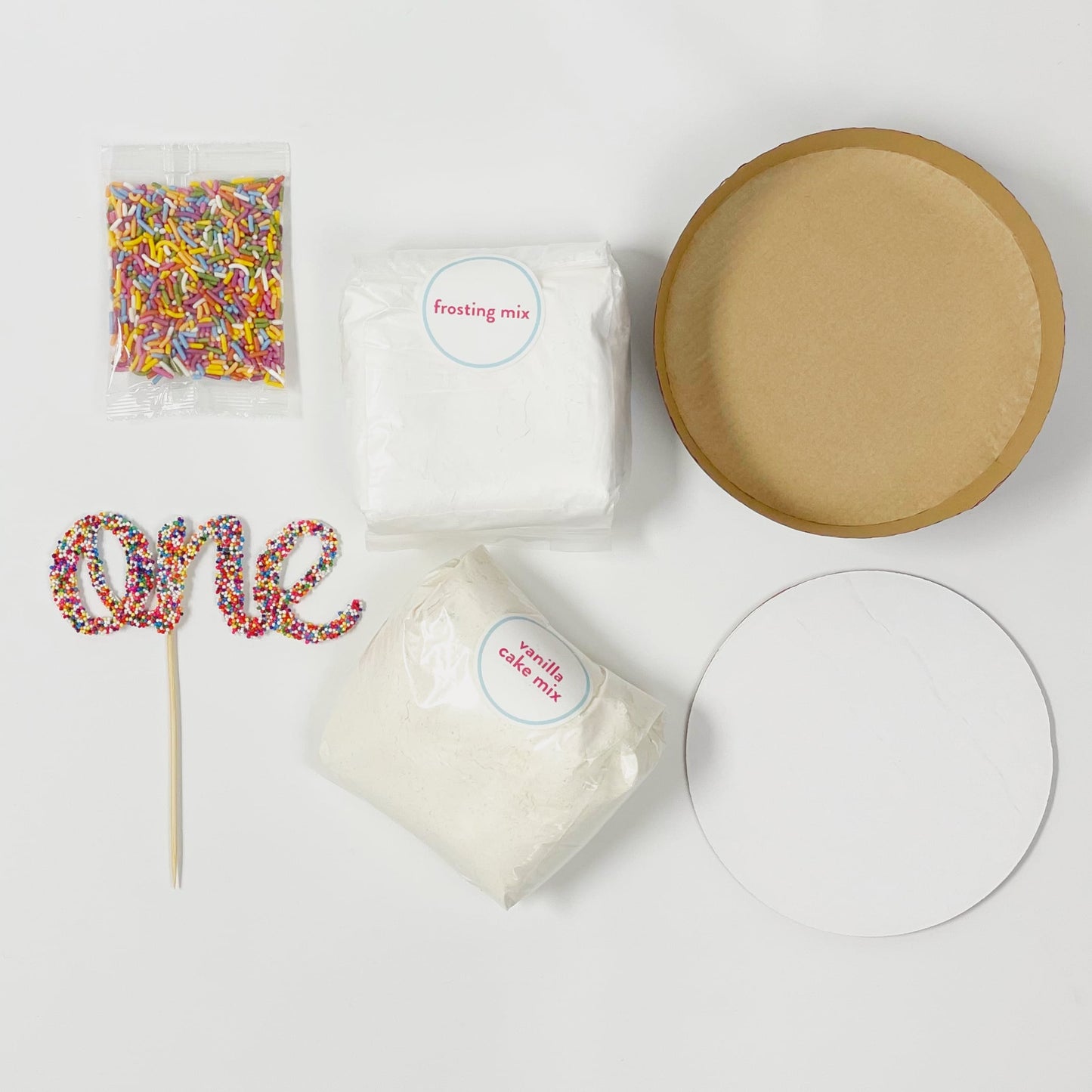 Smash cake kit with cake mix, frosting mix, sprinkles, and one sprinkle cake topper